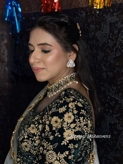 A side profile showing the soft, shimmery eyeshadow and the perfectly blended skin. This is a great look for any festive occasion.