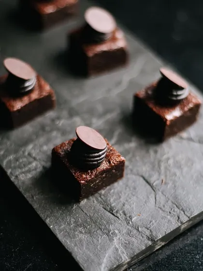 Bite-sized double chocolate cake squares, perfect for a dessert platter. These rich and fudgy bites are a chocolate lover's dream.
