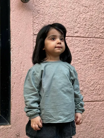 This little one posing with her fresh bob haircut. It's a chic and simple style that's perfect for kids.