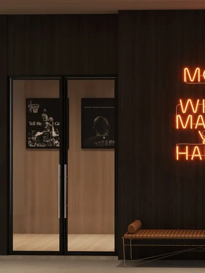 The entrance to the gym, featuring a neon sign with a motivational quote, setting the tone for the space.