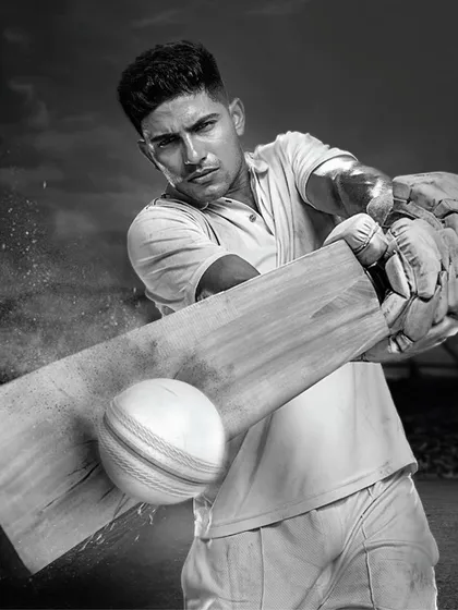 A powerful, dramatic shot of Shubman Gill for Engage by ITC. This black and white photo captures the intensity of a batsman in action, with the simple, classic cricket whites providing a timeless feel.