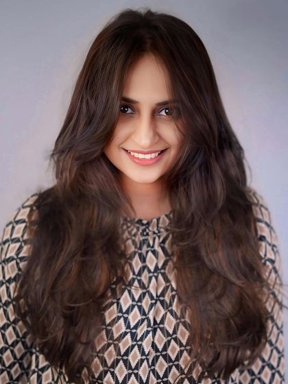 A front-on view of this beautifully layered and colored brunette style, perfect for adding volume to long hair.