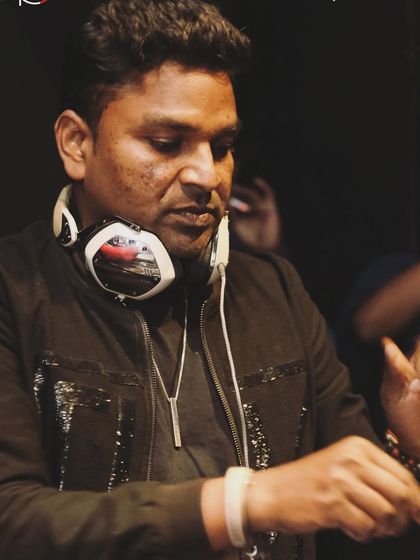 A close-up, focused shot while mixing. You can see the concentration it takes to blend tracks seamlessly and build a narrative.