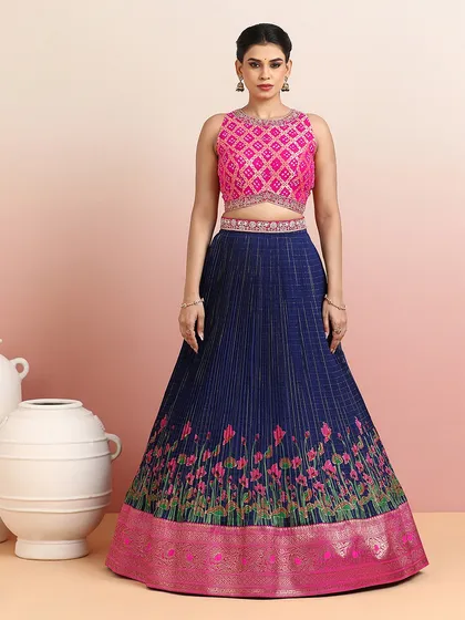 The full view of the navy and pink lehenga, showcasing the rich zari border and the contemporary cut of the blouse.