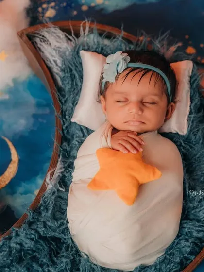 Cradled by the moon and holding a star. I use soft props and creative backdrops to make your newborn's first photos extra special.