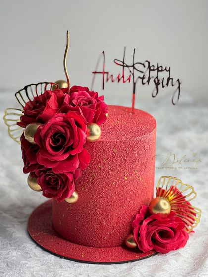 Roses are red, and this velvet-textured cake is a showstopper. The rich red color and floral decorations make it a perfect choice for a romantic anniversary celebration.
