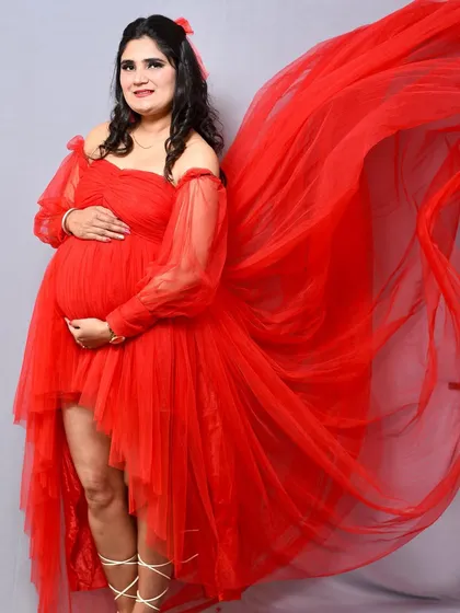 Another look at this stunning red gown in the studio. The way the fabric is tossed creates a different shape and feel, showing the versatility of a single outfit.