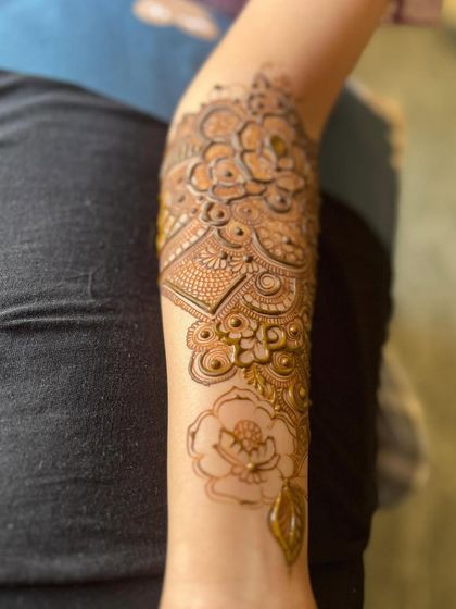 The back of the arm, showing a simpler floral vine.