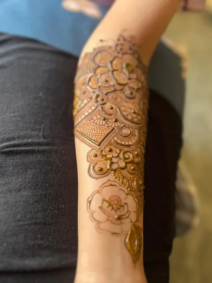 The back of the arm, showing a simpler floral vine.