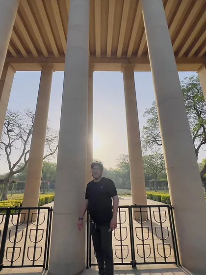 A member standing among the pillars of the cemetery. A powerful and poignant moment from one of our rides.