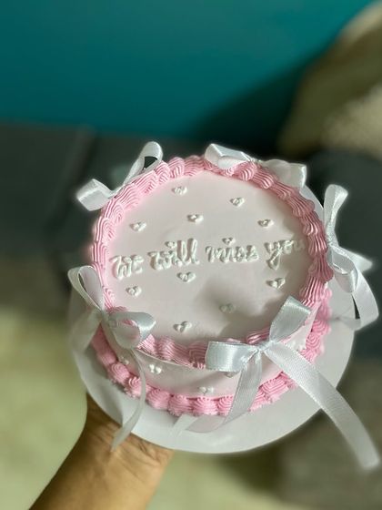 A sweeter cake for your sweet moments. This pretty pink chocolate truffle cake with white satin bows is perfect for a farewell party.