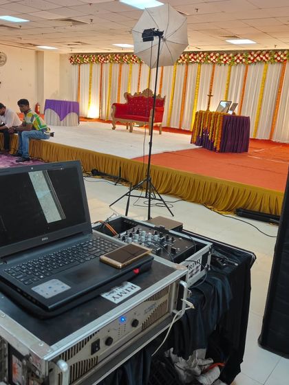 A 60th birthday celebration in progress. My DJ setup is visible in the foreground, providing music and sound for the event, while the stage is set for speeches and ceremonies in the background.