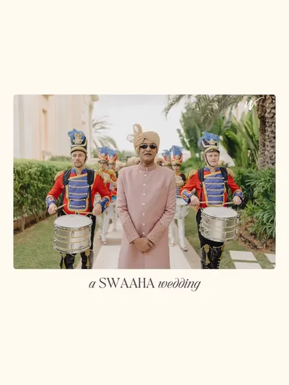 The father of the groom, looking sharp and ready, leads the baraat procession with a stylish marching band.