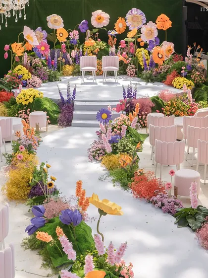 A surreal 'Blooming Day' wedding ceremony, where the aisle is lined with a rainbow of oversized, meticulously crafted paper and fresh flowers for a truly whimsical journey.