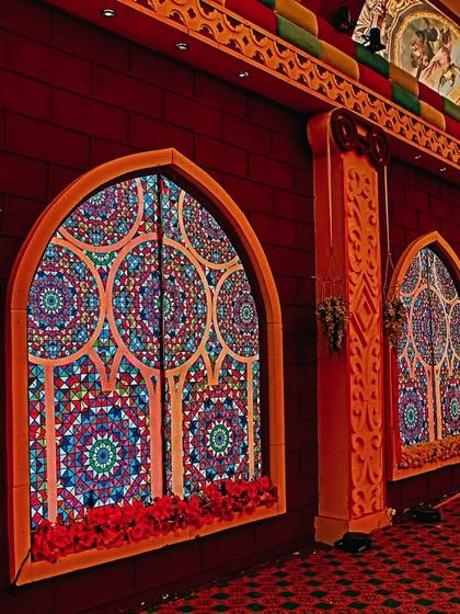 A side view of the artistic hallway, highlighting the intricate details on the walls and the colorful, mosaic-like window designs. This is an example of decor that is also a work of art.