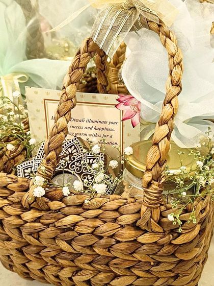 I love using natural materials in my hampers. This one is arranged in a hand-woven water hyacinth basket and includes a jar of goodies, a decorative mirror piece, and is beautifully wrapped with baby's breath flowers.