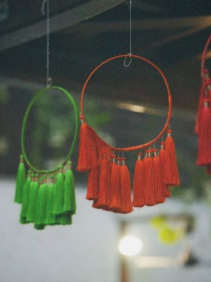 Colorful tassel dreamcatchers hanging from the ceiling. These fun, boho-chic elements added a playful and vibrant touch to the Mehendi party decor.