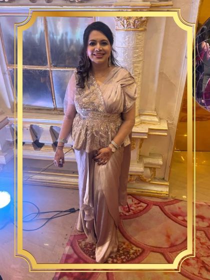 A full view of the client in the elegant draped gown with a peplum top. It's a sophisticated choice for any special occasion.