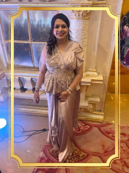 A full view of the client in the elegant draped gown with a peplum top. It's a sophisticated choice for any special occasion.