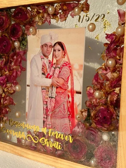 A side view of the teak wood frame, showing the depth and the glossy finish of the resin. The preserved flowers and photo are fully encased and protected.