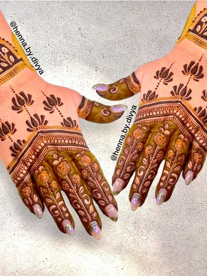 A unique design where the back of the hand is covered in floral patterns, while the front features minimalist lotus motifs. It's a great example of how different styles can be combined.