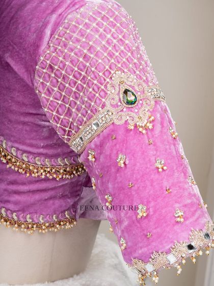 I love blending contemporary design with timeless fabrics. This lavender velvet blouse features a modern jewelry-like embellishment on the sleeves, with a mix of lattice work, pearls, and a central emerald-green stone.