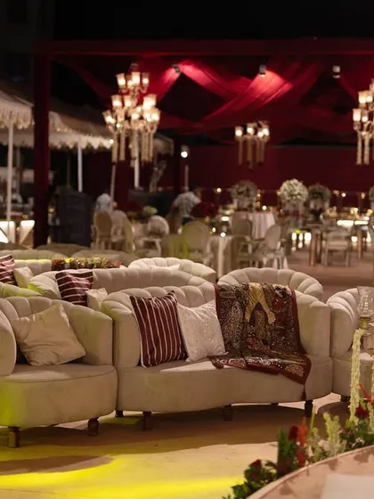 Luxurious lounge seating arranged for guest comfort. Even the relaxation areas are designed with opulence, featuring plush sofas and elegant decor to maintain the royal theme throughout the event.