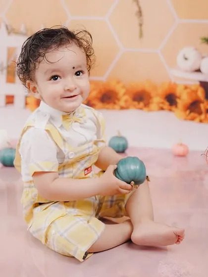 A heart-warming smile from the birthday boy as he plays with a pumpkin prop during his autumn-themed session.