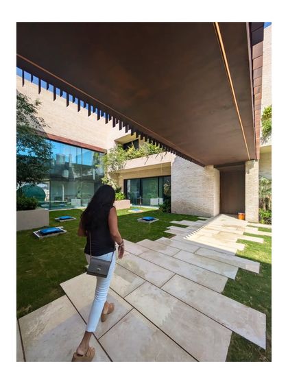A walkway through the courtyard of the Dubai Hills villa. The design creates a journey through a series of indoor and outdoor spaces, all connected by the central green oasis.