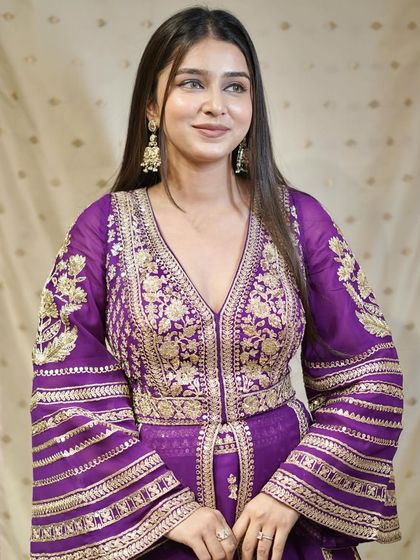 Regal reign! Make a majestic statement in this vibrant purple ensemble with flared sleeves.