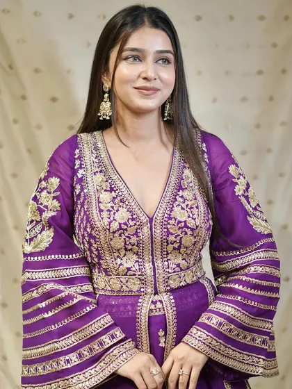 Regal reign! Make a majestic statement in this vibrant purple ensemble with flared sleeves.