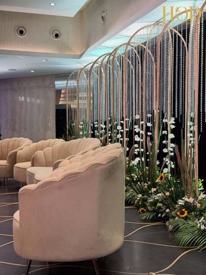 A side angle of the modern stage, showing the interplay of the arched backdrops, crystal strings, and the floral arrangements at the base.