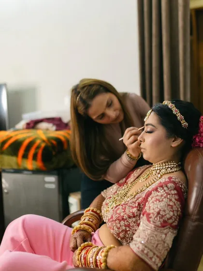 A candid moment captured by the photographer. Here I am, focused on perfecting the bride's eye makeup.