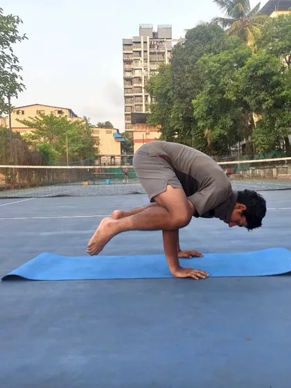 This advanced arm balance pose, the Bakasana or Crow Pose, requires immense upper body strength and focus, skills that translate directly to stability and power on the tennis court.