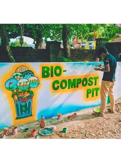 An identical shot of me painting the mural. It captures a moment of focus as I add details to the illustration, ensuring the message is clear and the artwork is clean.