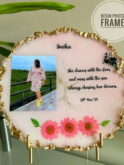 A still shot of the beautiful pink resin photo frame with the quote, "She dances with the stars and runs with the sun, always chasing her dreams." It's an inspiring and personal piece of decor.