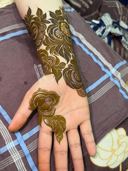 A simple yet elegant rose motif on the palm, perfect for an engagement or for a bride who prefers a more minimalist design.