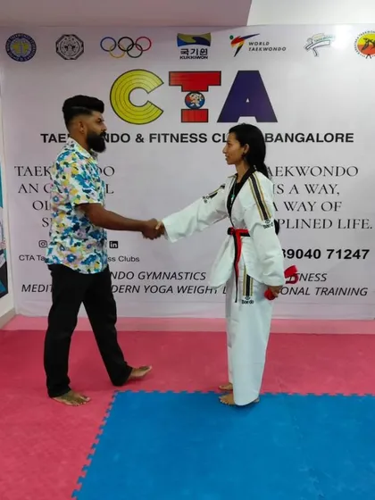 A handshake for a new red belt.