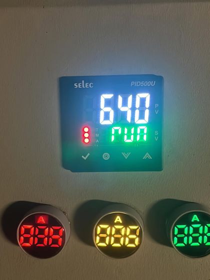 The digital controller for our electric kiln during a run. This equipment allows for precise temperature control, which is crucial for achieving specific results in glazing and firing.