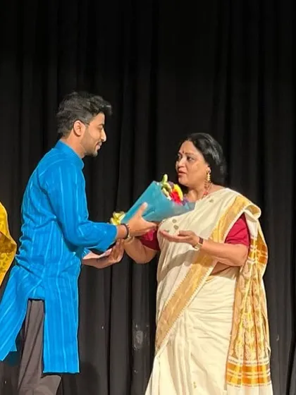 Receiving flowers on stage as a token of appreciation after the show.