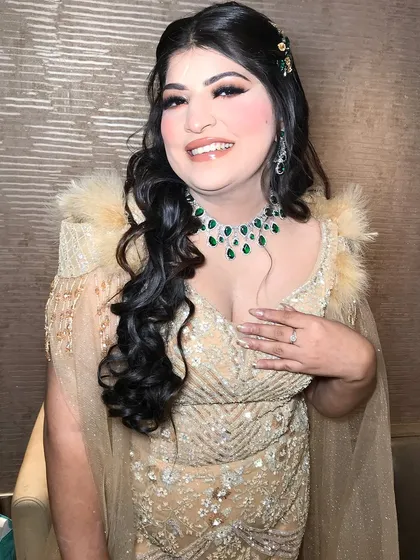 A happy, smiling bride, her joy evident. The emeralds add a touch of royalty to her look.