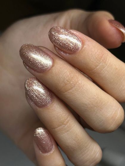 A soft, rose-gold cat-eye manicure. The magnetic shimmer gives this popular metallic shade a beautiful, velvety finish.