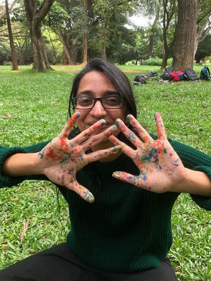 Another happy participant with colorful hands after a playful art session. This is what pure creative joy looks like.