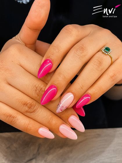A vibrant and playful multi-tonal pink manicure. This design uses shades from bright fuchsia to soft baby pink, with one accent nail featuring delicate glitter for extra sparkle.