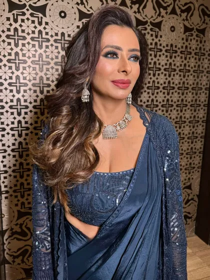A close-up of this glamorous mom's makeup. The smokey eye is the star, but her skin is also glowing, and her lips are a perfect shade of berry.