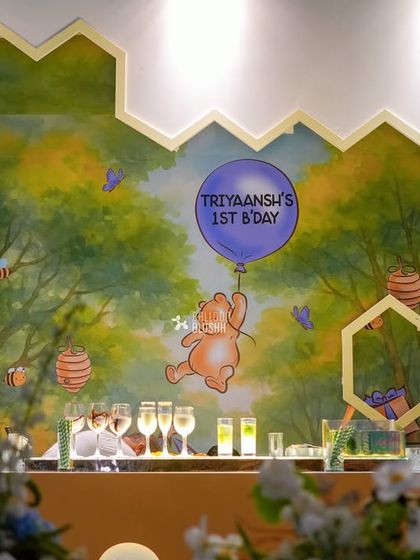 A custom-painted honeycomb backdrop for the bar, featuring Pooh floating with a balloon. This hand-painted detail adds an artistic and bespoke touch.