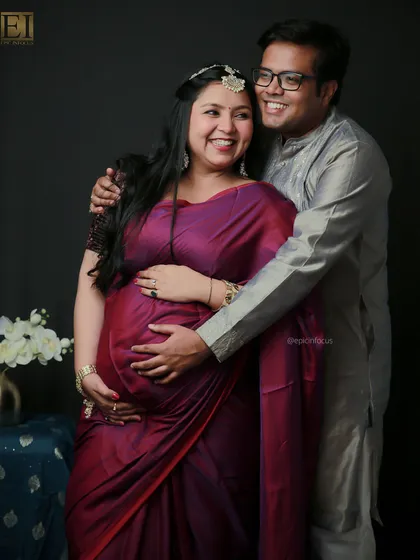 Laughter and love fill this frame. A candid shot of a couple enjoying their traditional-themed maternity session in our studio.