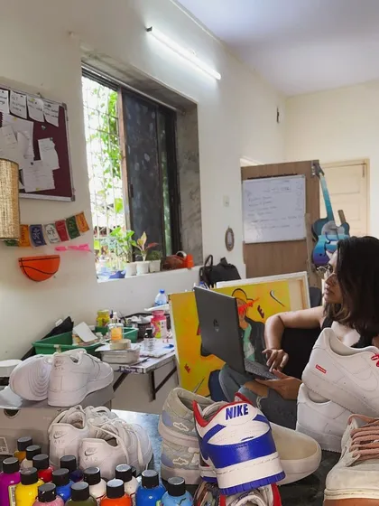 Here I am in my creative space, surrounded by paints, brushes, and a few works-in-progress. This is where I check emails and work on digital mockups for new projects.