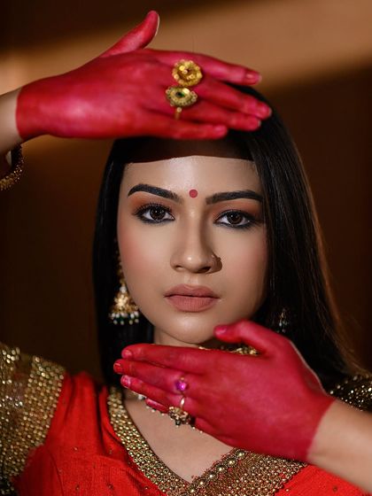 This creative portrait uses the model's alta-stained hands to frame her face, creating a visually interesting composition that is both beautiful and symbolic.