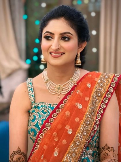 The lovely Shruti for her Mehendi ceremony. Her look is classic and elegant, with a simple updo and a flawless base.